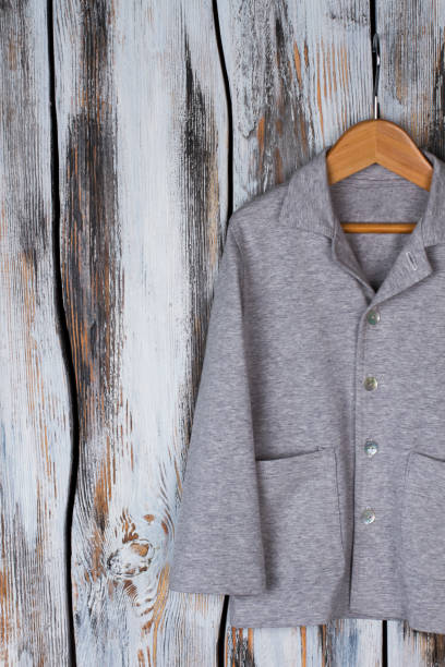 istock Gray shirt on wooden hanger 891814824