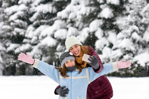 istock Girls makes a selfie in winter day. 891829372