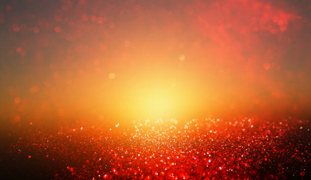 istock black, gold and red glitter lights background. defocused. 891832492