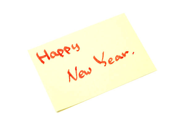 istock Happy new year writen on yellow sheet, white background 891838206