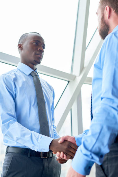 istock Serious multiethnic business partners shaking hands 891838214