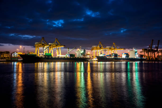 istock Logistics and transportation of Container Cargo ship and Cargo plane with working crane bridge in shipyard at sunrise, logistic import export and transport industry background 891840636
