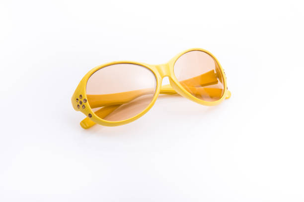 istock The yellow sunglasses on white background. 891843426