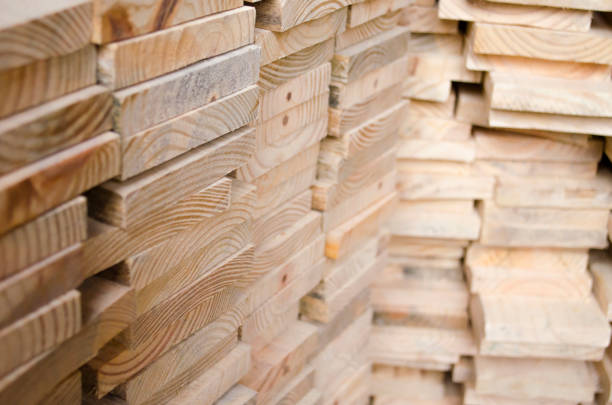 Stacked plates of wood in warehouse for buildings construction - Furniture production concept on timber wooden industry for woodwork import and export