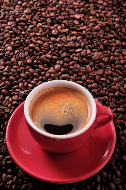 istock Red coffee cup with espresso and roasted beans vertical 891859110