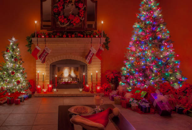 istock Christmas fireplace, tree and cookies in candlelight (P) 891863914