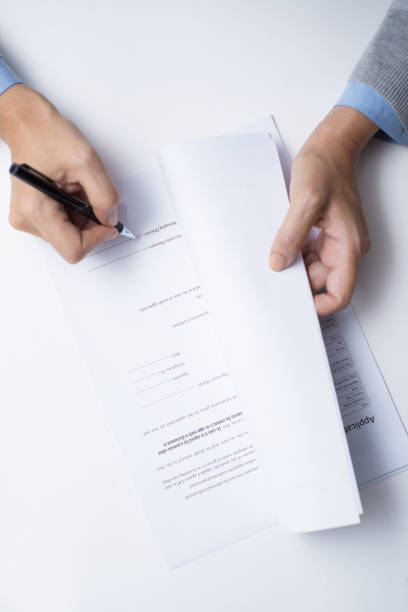 istock Businesswoman signing document after reading 891869584