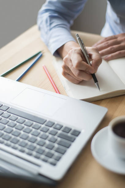 istock Closeup of Employee Making Notes in Office 891872538