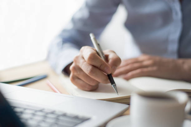 istock Closeup of Woman Making Notes in Office 891872618