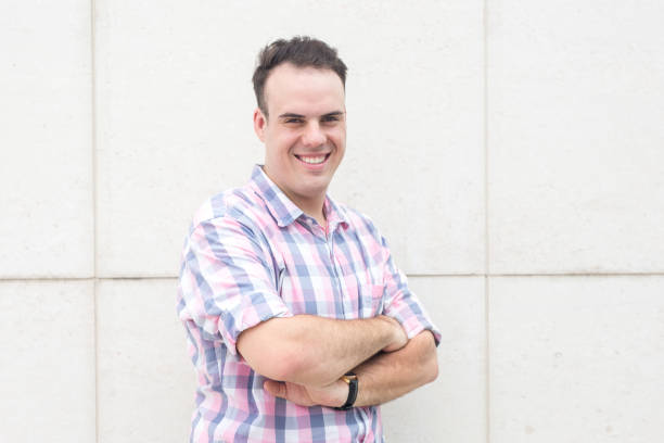 istock Portrait of successful young man standing at wall 891875092