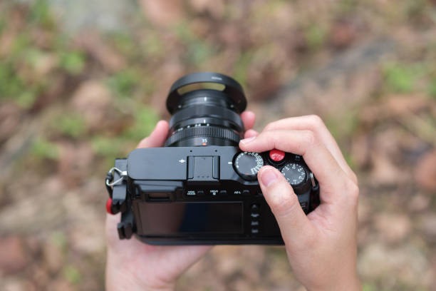 istock Photographer, Camera on hand. Photograph hobby 891879952