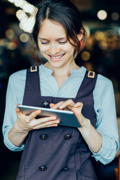 istock Closeup of Smiling Nice Woman Networking on Tablet 891882592