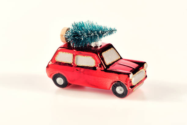 istock Small bright red toy car with Christmas tree 891900764