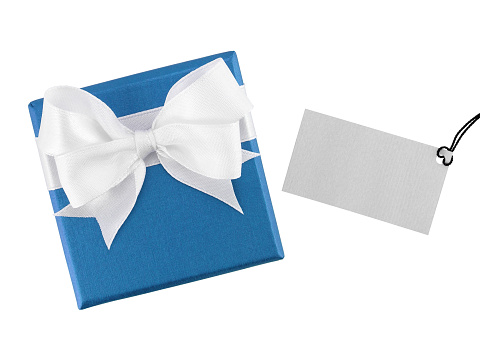 blue gift box with white ribbon bow and blank gray greeting card for writing message isolated on white background, close-up top view flat lay