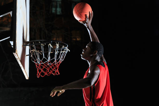istock African basketball player slam dunking 891926092