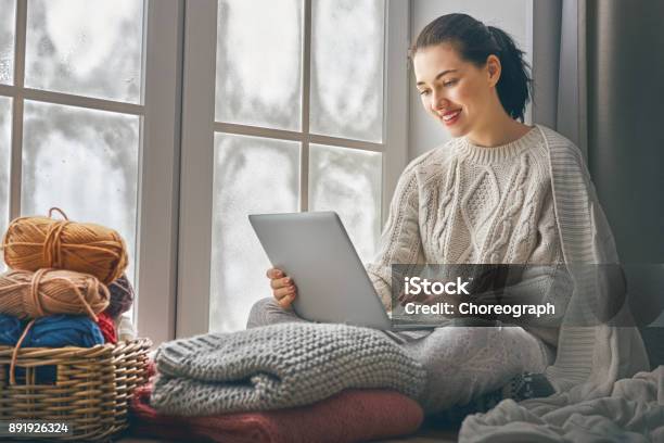 Woman Sitting Near Windows Stock Photo - Download Image Now - Winter, Laptop, Home Interior