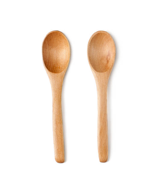 istock Two teaspoons of natural wood. Isolated on white background. 891931244