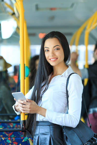 istock Cheerful young woman traveling and using smart phone 891940046
