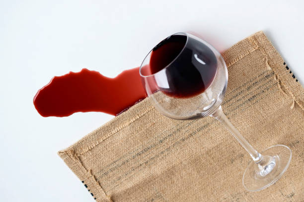 istock tumbled glass goblet on the table from it pours out red wine, the concept. 891940088