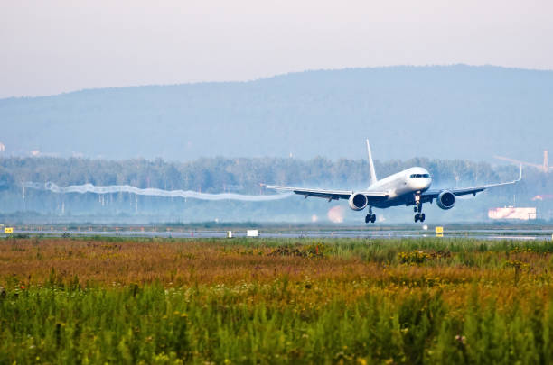 istock Passenger plane before touching runway landing with vortexes coming from wingtips. 891940218