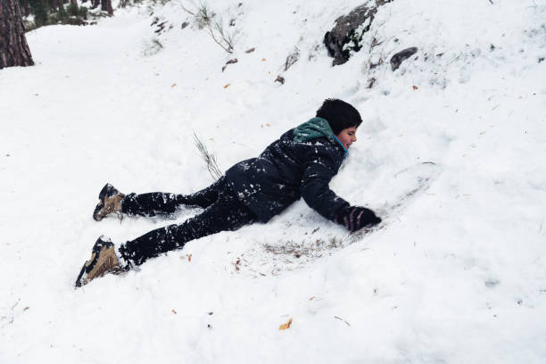 istock Young boy having fun with snow in the mountain 891940354