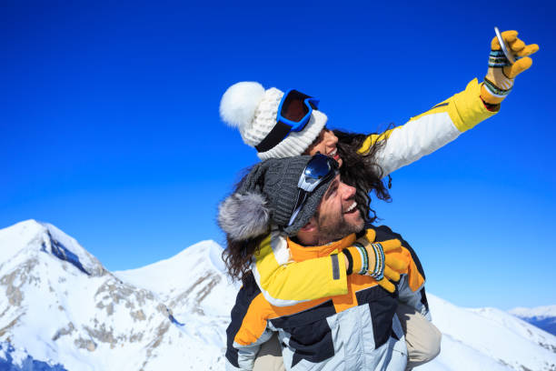 istock Young couple skiers taking selfie on top snow mountain 891945480