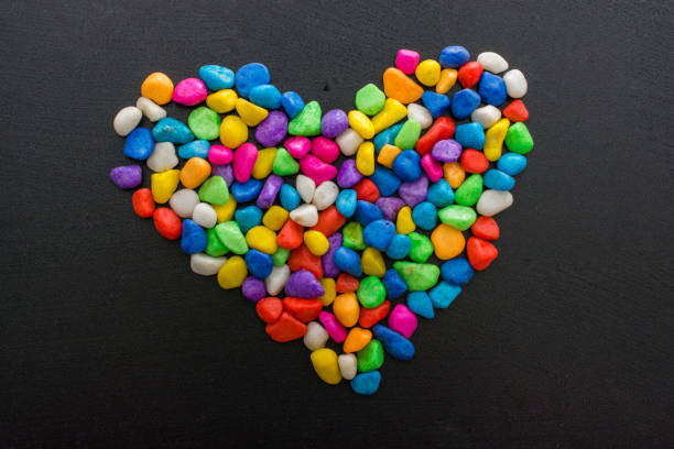 istock Colorful little pebbles form a heart shape 891946184
