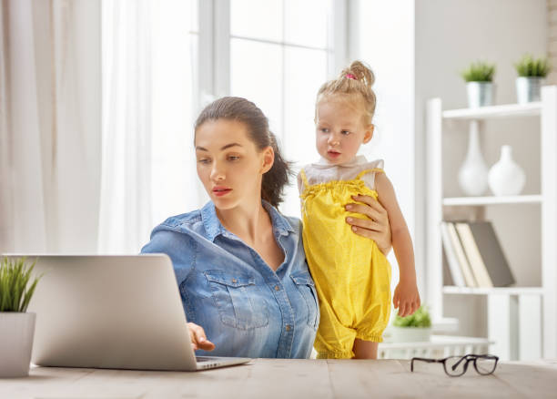 istock mother with toddler working 891949118