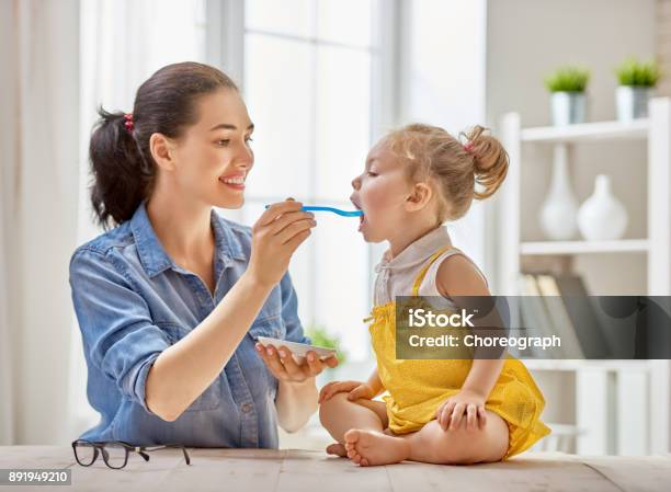 Mother Feeding Her Child Stock Photo - Download Image Now - Baby - Human Age, Feeding, Eating