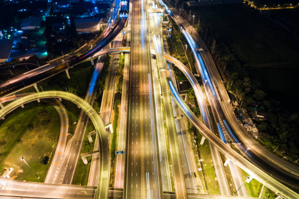 istock Aerial view night city traffic freway intersection road long exposer 891952228