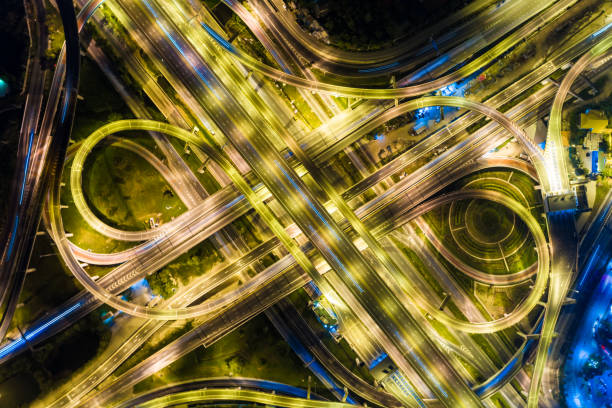 istock Aerial view night city traffic freway intersection road long exposer 891952300