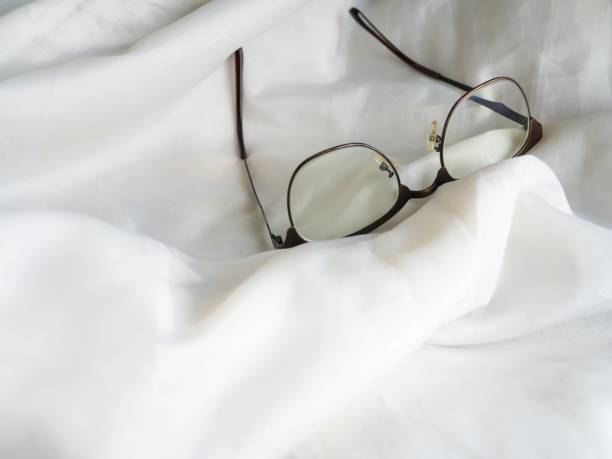 istock Eye glasses in the bed 891952444