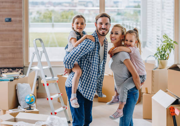 istock Happy family piggybacking while moving into new apartment. 891953742