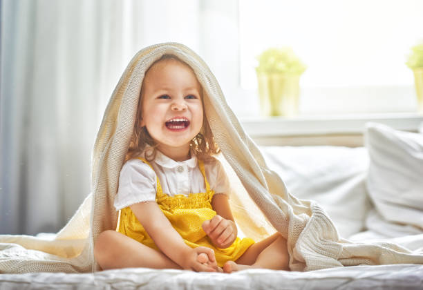 chica bebé en la cama - baby cute laughing human face fotografías e imágenes de stock