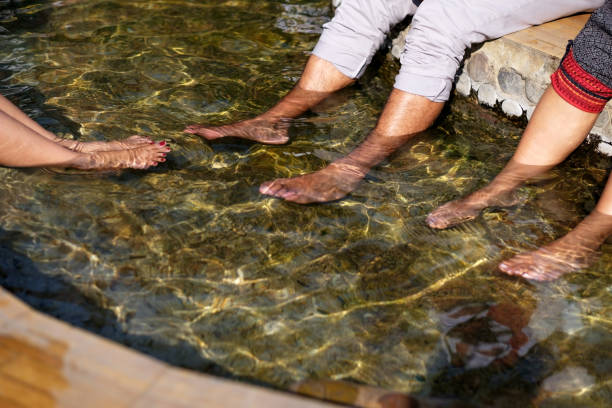 istock People warm their feet in a hot spring. 891955956
