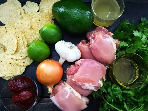 Chicken thighs, onion, garlic, lime, ancho chili peppers, tortilla chips, avocado, chicken broth, cilantro and olive oil