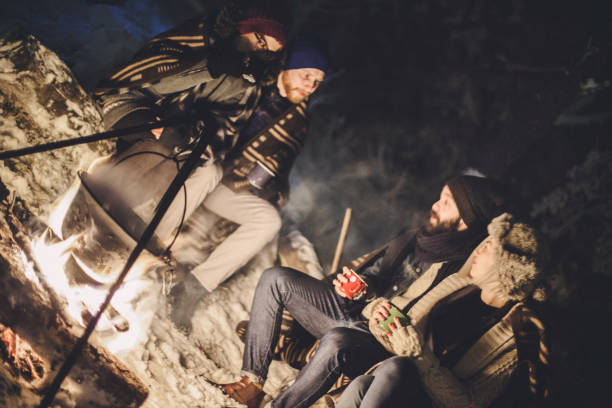 istock Friends camping on snowy mountain 891968638
