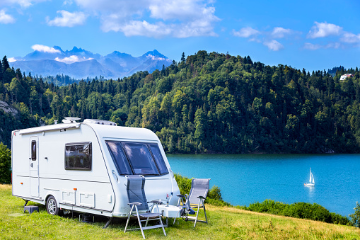 Summer scene with camper trailer by the Czorsztyn lake and Tatra Mountains landscape, Poland