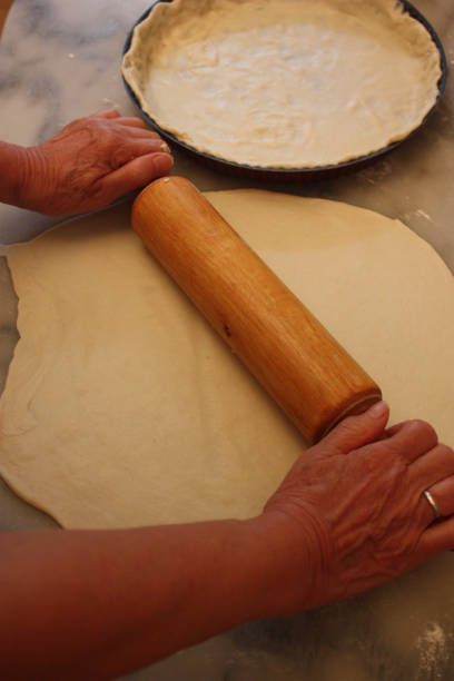 istock Preparation of a dough with a rolling pin 891972246