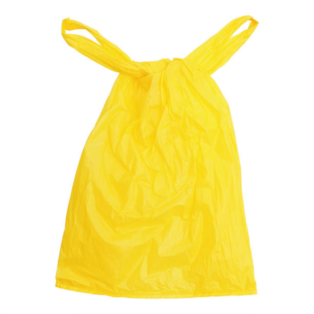 istock one tied yellow plastic bag isolated on white 891972402