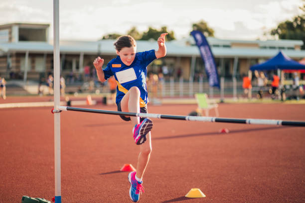 Doing The High Jump At Athletics Club Little girl is training for the high jump at athletics club. high jump stock pictures, royalty-free photos & images