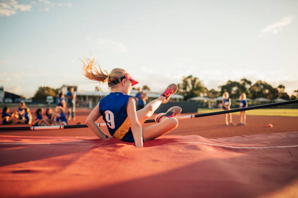 Unsuccesful High Jump Attempt Little girl is landing on the mat after an unsuccesful high jump in athletics club. high jump stock pictures, royalty-free photos & images