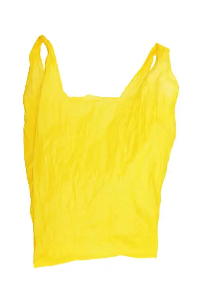 Photo of one open wrinkled yellow plastic bag isolated on white