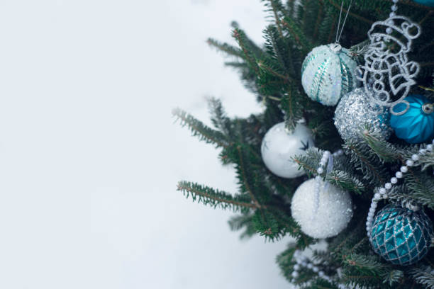 istock White, silver and blue baubles on a Christmas tree 891982348