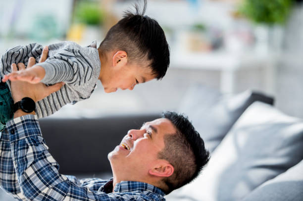 istock Holding His Son In The Air 891982510