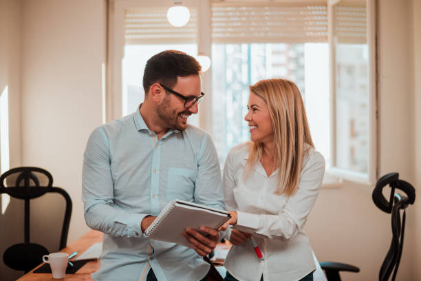 istock Woman working with her colleague in the office. 891991270