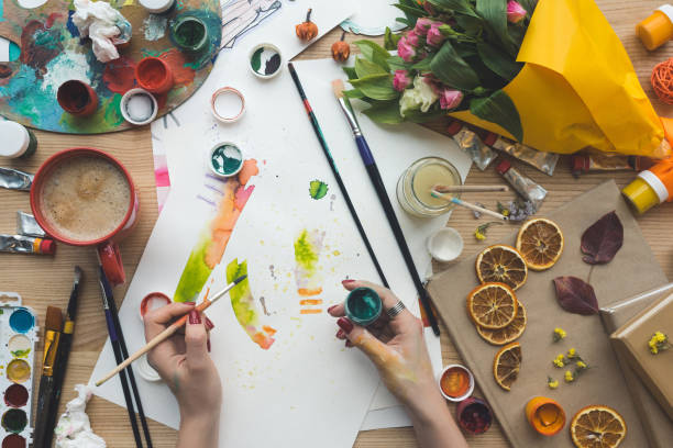 istock designer holding brush and poster paint 891992180