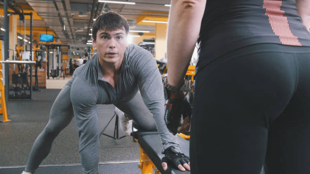 istock In the gym - athlete man lifting dumbbells 891996152
