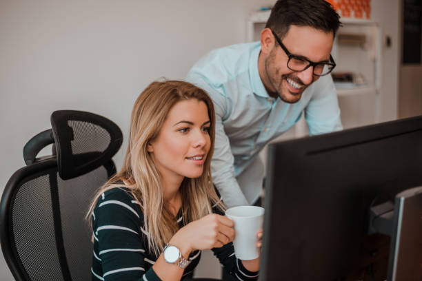 istock Two corporate business colleagues working together in office. 891996634
