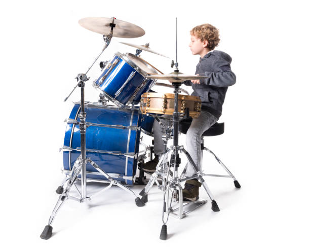 istock young blond caucasian boy at drumset in studio 891996650